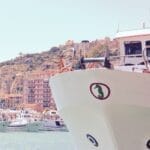 people riding on white boat on sea during daytime